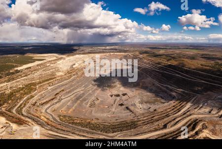 Huge granite quarry in europe aerial view. Panorama on a granite mining facility Stock Photo