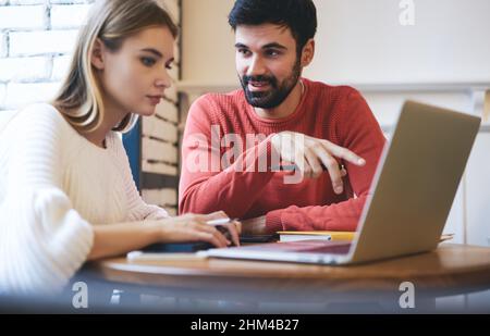 Concentrated freelancers working in cafe Stock Photo