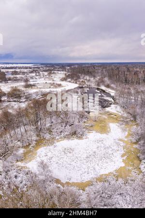 Rural winter lanscape. Aerial view on a river. River flowing through snow covered nature Stock Photo
