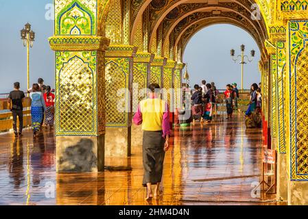 Mandalay, Myanmar - December 25, 2019: People in Sutaungpyei Pagoda at Mandalay Hill. Many people go up the hill to watch the sunset over the city Stock Photo