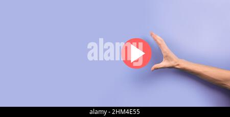 Businessman pressing, hold play button sign to start or initiate projects.Video Play Presentation. Idea for business, technology.media player button. Stock Photo