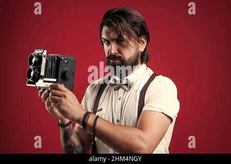 Free: man sitting while holding black DSLR camera - nohat.cc