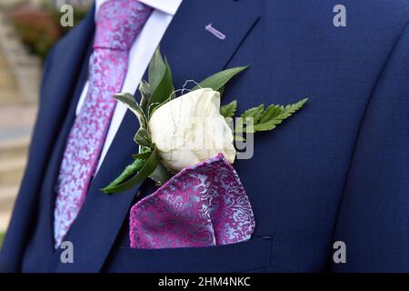 Close up of Groom's buttonhole, tie and jacket on his wedding day. UK Stock Photo