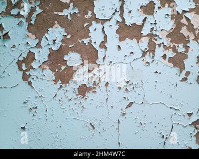 Background texture wall with peeling paint. Peeling old paint off the wall. Stock Photo