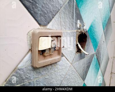 Broken socket and switch. Switches on the old wall. Very old house and renovated. Stock Photo