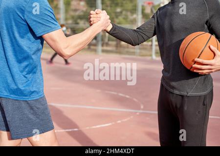 unrecognizable friends high-fiving each other on the court. concept of sport and friendship Stock Photo