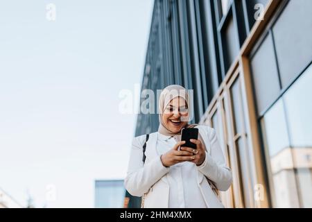 Smiling woman using cell phone Stock Photo