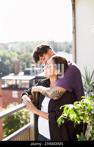 Couple standing on balcony Stock Photo