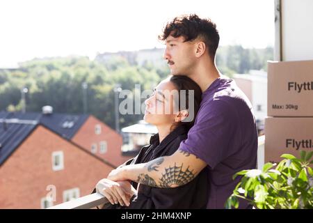 Couple standing on balcony Stock Photo