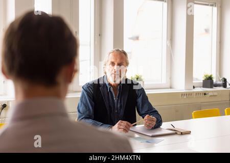 Businessmen talking during meeting Stock Photo