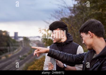 Male friends talking together Stock Photo