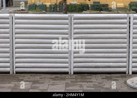 White Wood Logs Wall Structure Fence Divider at Street Stock Photo