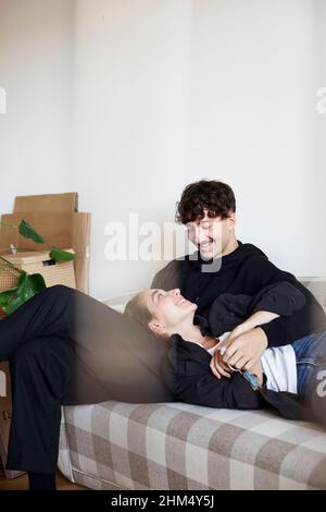 Young couple sitting on sofa Stock Photo