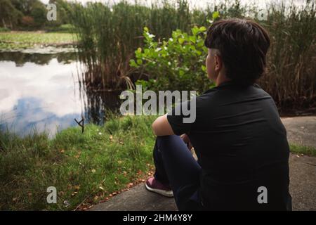 Young woman relaxing at lakeside Stock Photo