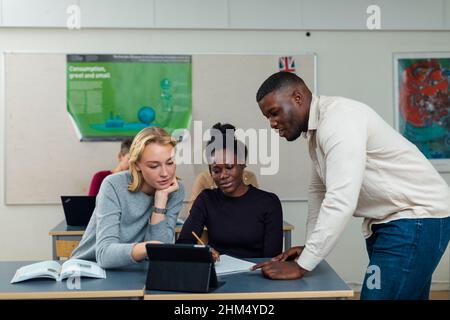 Male teacher helping student Stock Photo
