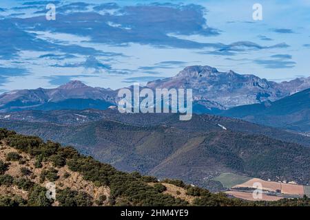 View from viewpoint Santa Cruz de la Seros, Huesca, Spain. The mountains in the background and the blue sky with clouds. Stock Photo