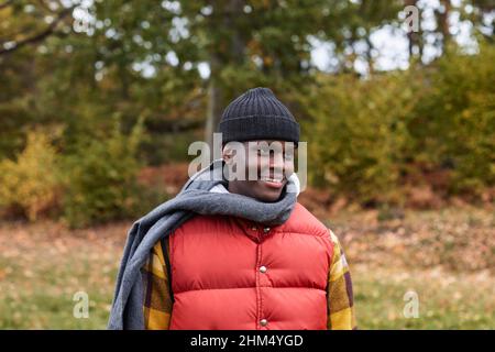 Smiling young man in knit hat and scarf Stock Photo