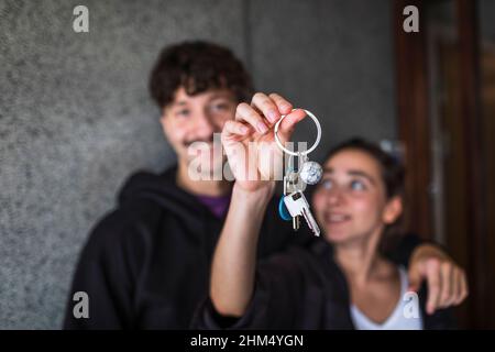 Couple showing keys to new apartment Stock Photo