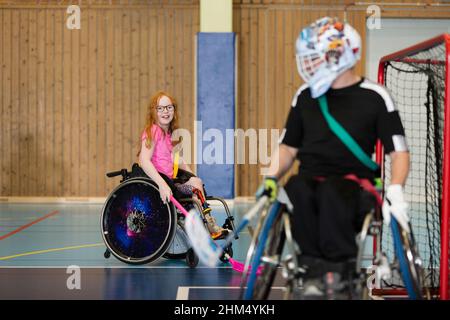 Disabled people playing in gym Stock Photo