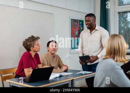 Male teacher helping student Stock Photo