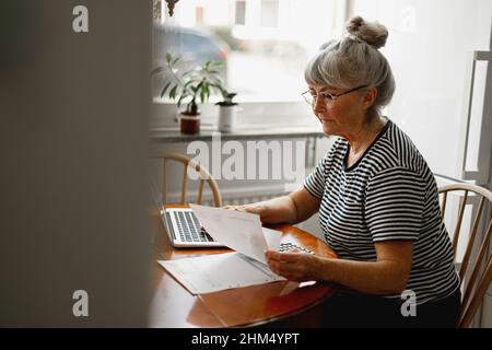 Senior woman using laptop Stock Photo