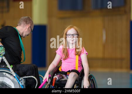 Disabled people playing in gym Stock Photo
