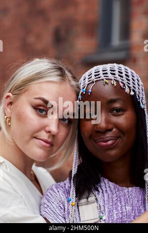 Smiling friends looking at camera Stock Photo