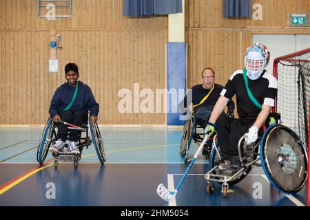Disabled people playing in gym Stock Photo