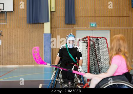 Disabled people playing in gym Stock Photo