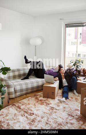 Young couple sitting in living room Stock Photo