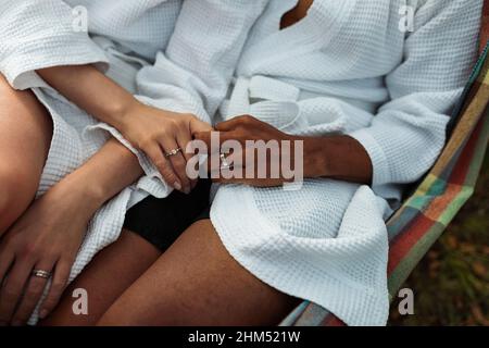 Mid section of couple holding hands Stock Photo