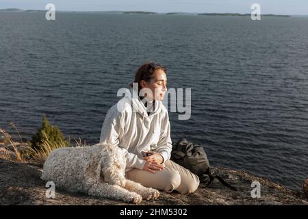 Woman with dog at sea Stock Photo