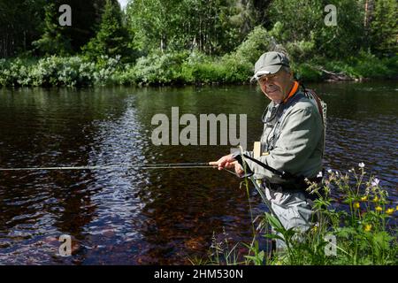 Man fishing in river Stock Photo