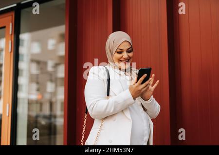 Smiling woman using cell phone Stock Photo