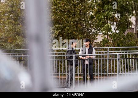 Male friends talking together Stock Photo