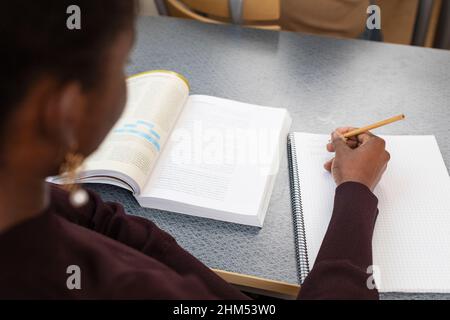 Mid section of woman writing Stock Photo