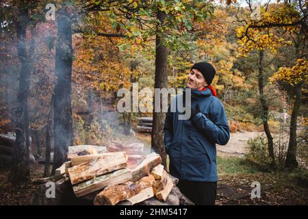 Man making campfire in forest Stock Photo