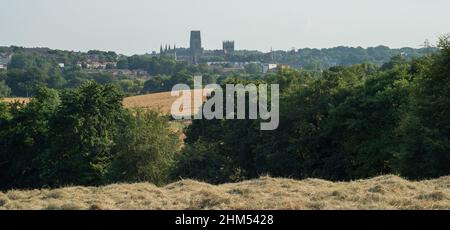 View of Durham Cathedral across open fields ready for harvesting from the pilgrims path of Camino Ingles to Santiago Stock Photo