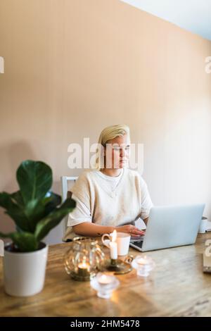 Woman using laptop at home Stock Photo
