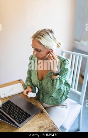 Woman using laptop at home Stock Photo