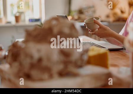 Female potter involved in work at her workshop Stock Photo