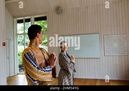 Smiling couple in yoga studio Stock Photo