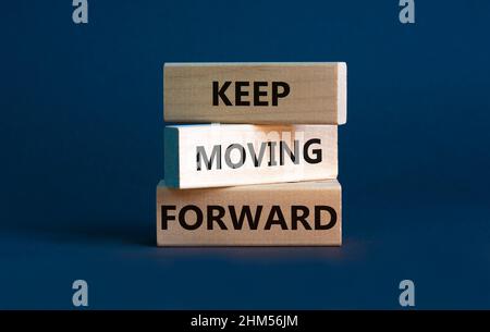 Keep moving forward symbol. Concept words Keep moving forward on blocks on beautiful grey table grey background. Business, motivation and keep moving Stock Photo