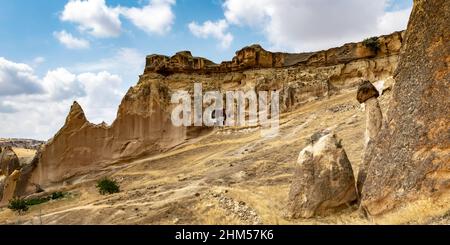 Impressive ancient cave home which had been carved in the Vulcanic rock cliff face of Pigeon Valley at Uchisar in the Cappadocia region of Turkey. Stock Photo