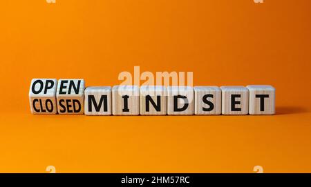 Open or closed mindset symbol. Turned wooden cubes and changed concept words closed mindset to open mindset. Beautiful orange background, copy space. Stock Photo