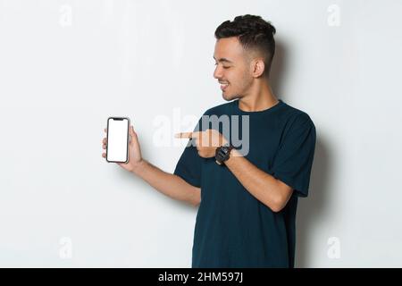 young man demonstrating mobile cell phone on white background Stock Photo