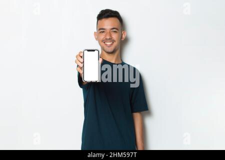young man demonstrating mobile cell phone on white background Stock Photo
