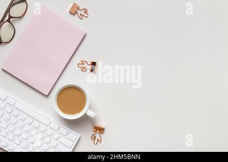 Desktop. Notepad keyboard cups of coffee glasses on the table. Top view flat lay copy space Stock Photo