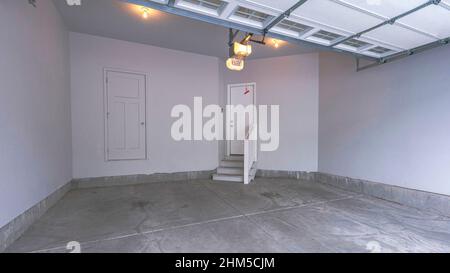Panorama Interior of a garage with over the canopy garage door with window panels Stock Photo