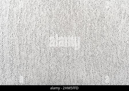 Thick fabric for upholstery in light gray. Texture. Material for a seamstress, tailor, fashion designer Stock Photo